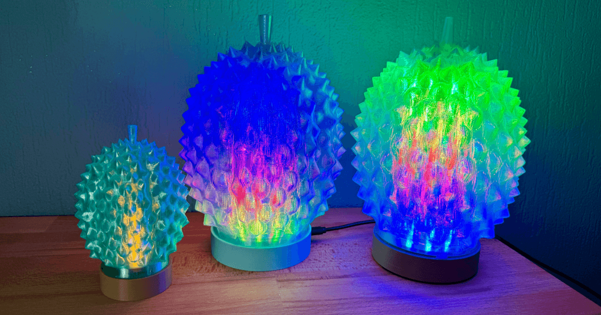 Three 3D printed durian lamps in different sizes, illuminated with colorful RGB LED effects.